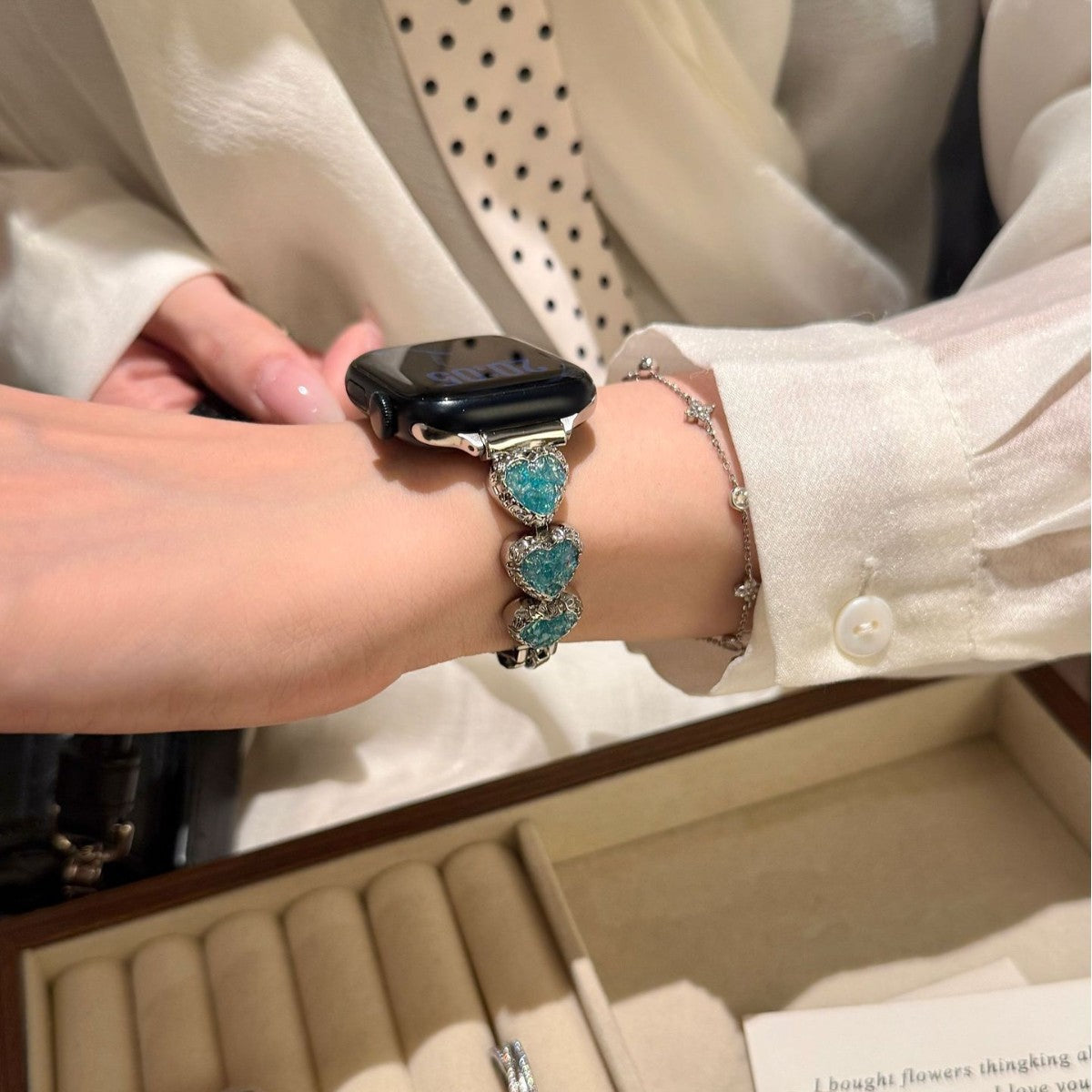 Wearing the turquoise glitter heart charm watch strap with silver jewelry